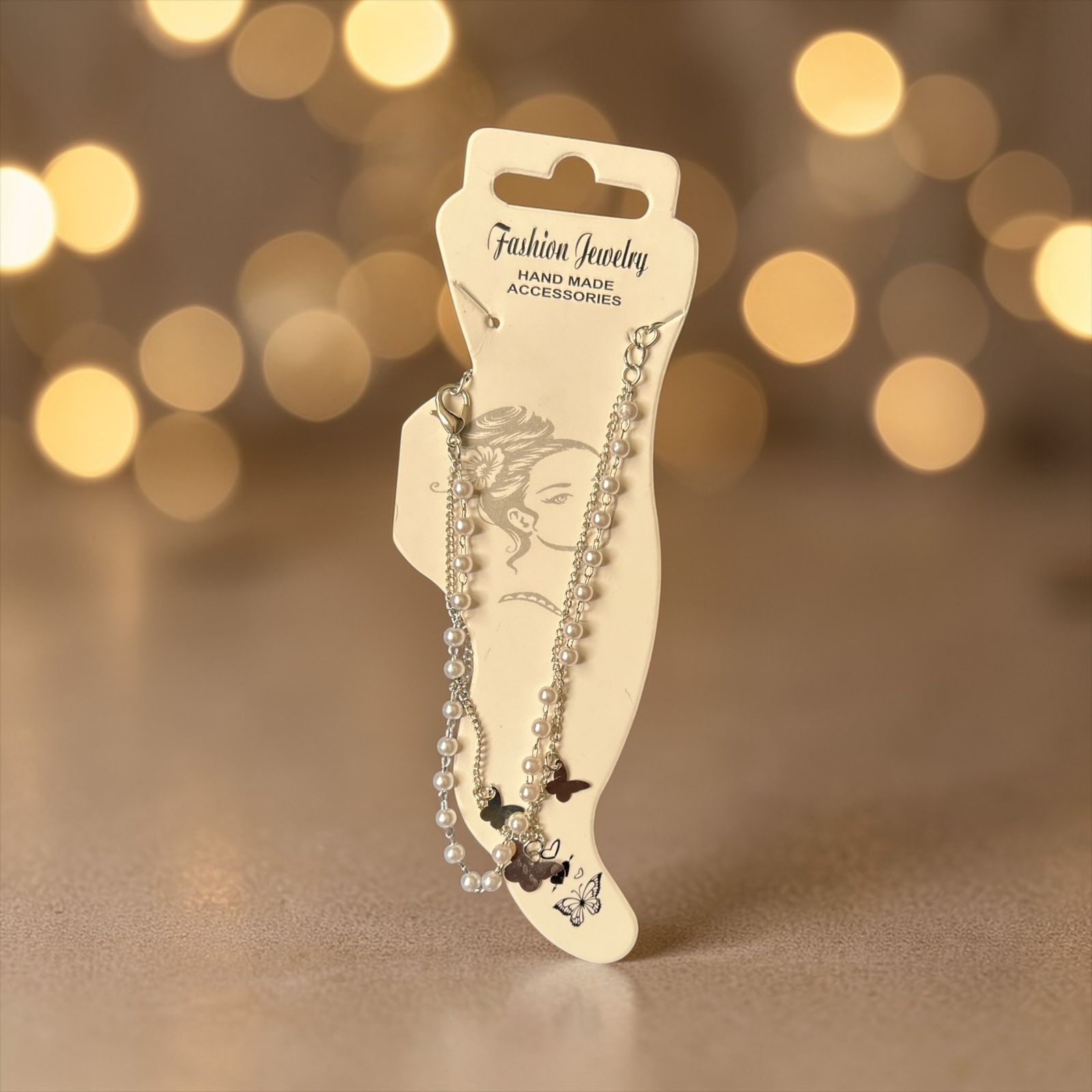 silver anklet with small pearls and butterflies' charm